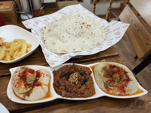 Fries and "salad trio" (hummus, muhammara and mutabbal with bread) at Zatar Pizza in Yerevan