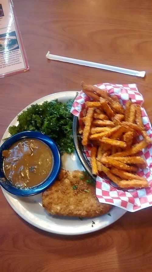 Fried chikin with mushroom gravy and kale salad. Substituted sweet potato for mashed potato. at Green Vegetarian Cuisine - Quarry Market in San Antonio