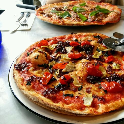 Classic base with artichoke, pepperdew peppers, caramelised onion and garlic oil. And a Caponata with vegan cheese. at Pizza Express in Cheltenham
