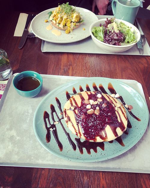 Berry pancakes and bagel with scrambled tofu  at Beetnut in Zurich