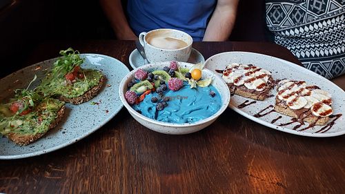 Avocado kale toast, Aloha Bowl, Choco banana toast, almond milk latte. at Beetnut in Zurich