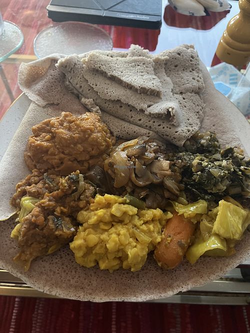 Veggie sampler, mushroom tibs, and shuro with teff injera  at Moya in San Francisco