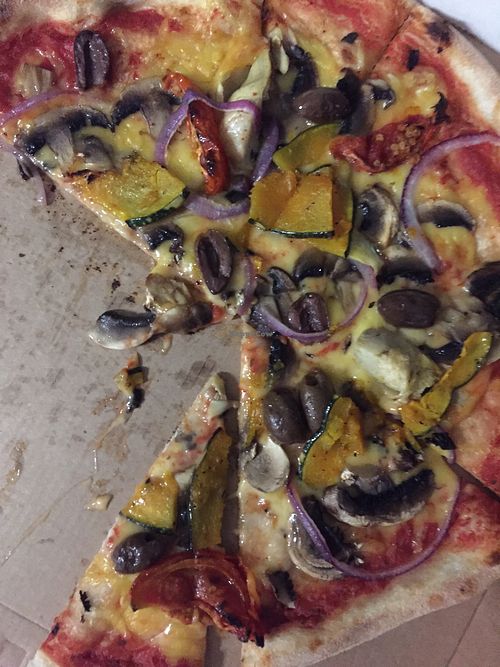 Vegetarian pizza with vegan cheese  at The Pizza Shop in Port Douglas